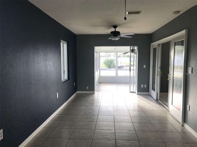 4127 Gardner Dr, Port Charlotte, FL 33952 - tiled empty room with baseboards, visible vents, ceiling fan, and a textured wall