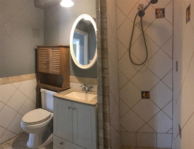 4127 Gardner Dr, Port Charlotte, FL 33952 - bathroom with a shower, a wainscoted wall, tile walls, toilet, and vanity