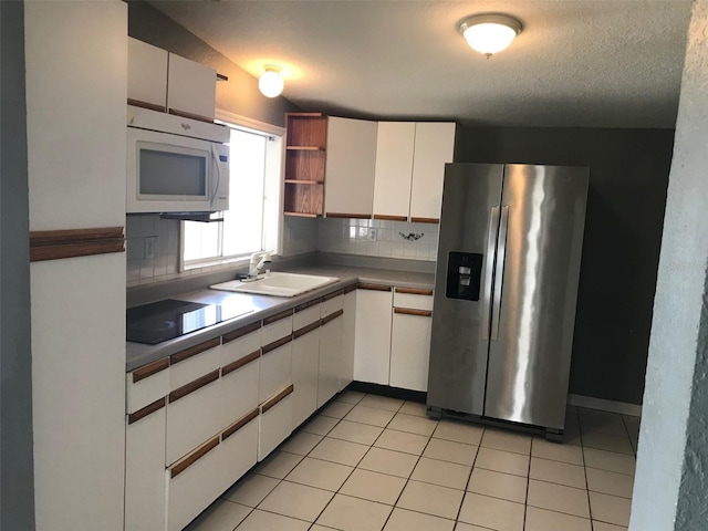 4127 Gardner Dr, Port Charlotte, FL 33952 - kitchen featuring white cabinetry, a sink, stainless steel fridge with ice dispenser, and white microwave