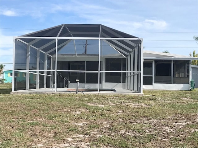 4127 Gardner Dr, Port Charlotte, FL 33952 - rear view of property featuring glass enclosure and a lawn
