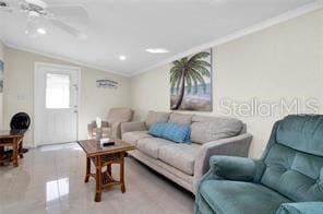 tiled living room featuring crown molding, vaulted ceiling, and ceiling fan