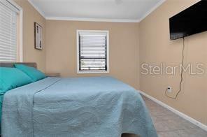 bedroom with ornamental molding