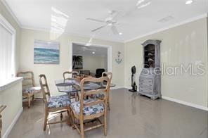 dining area with crown molding and ceiling fan