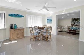 dining room with crown molding, plenty of natural light, and ceiling fan