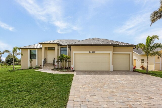 view of front of home with a front lawn and a garage