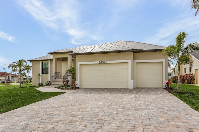 view of front of home with a front yard and a garage