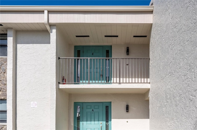 1439 Mediterranean Dr Unit C, Punta Gorda, FL 33950 - doorway to property featuring a balcony and stucco siding