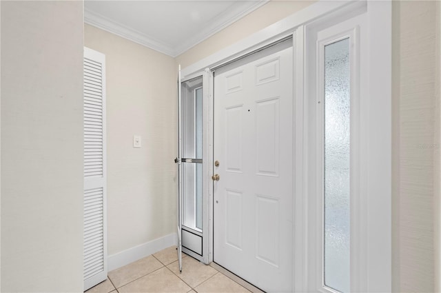 tiled entryway featuring crown molding