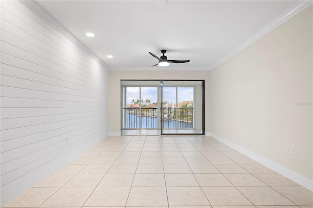 tiled spare room featuring crown molding and ceiling fan