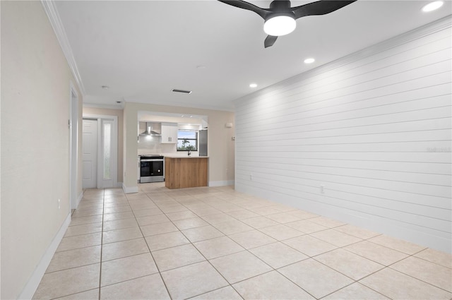 unfurnished living room featuring ceiling fan, light tile patterned floors, and ornamental molding