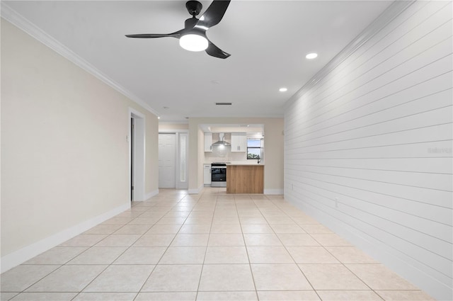 unfurnished living room with ornamental molding, ceiling fan, and light tile patterned flooring