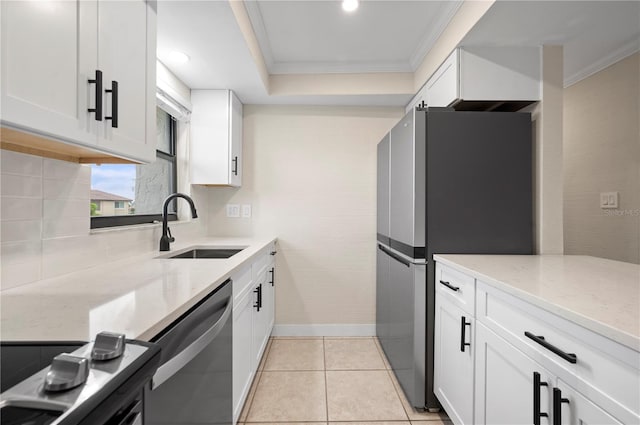 kitchen featuring light stone countertops, white cabinetry, appliances with stainless steel finishes, and sink