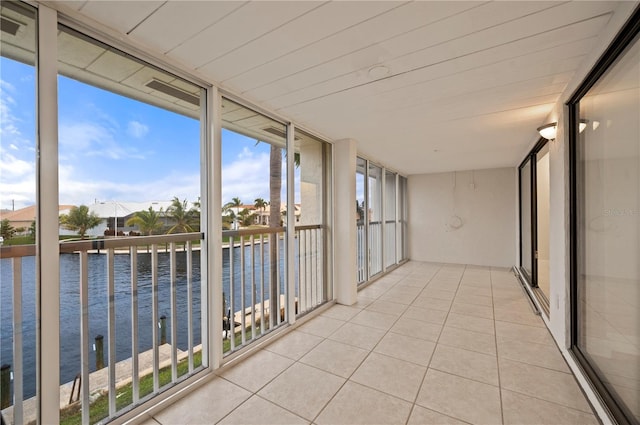 unfurnished sunroom with a water view