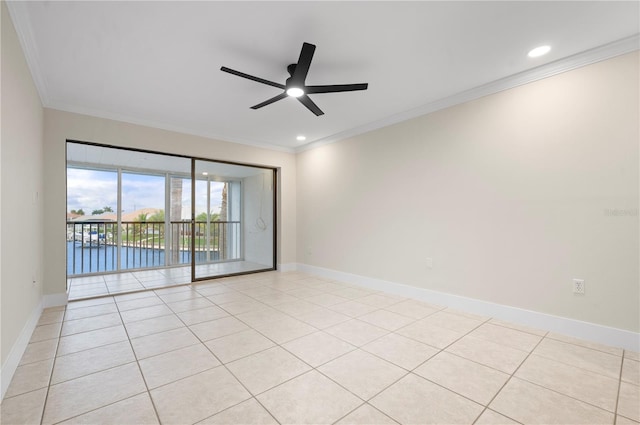 spare room featuring ceiling fan, light tile patterned flooring, and crown molding