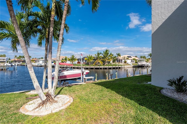 view of dock featuring a water view and a yard