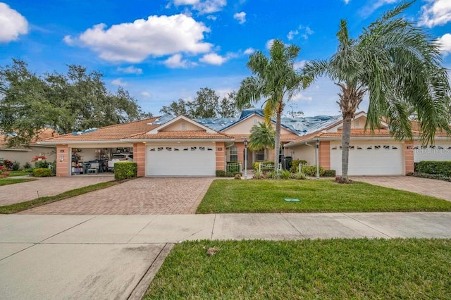 ranch-style home with a front yard and a garage