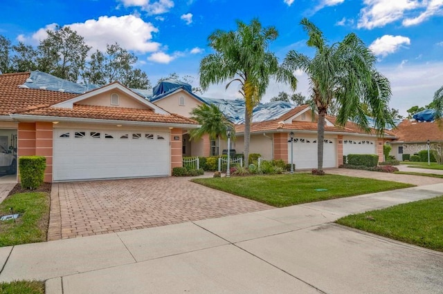 view of front of home with a front yard and a garage