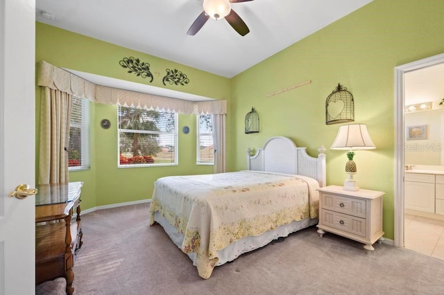 carpeted bedroom featuring ensuite bath and ceiling fan