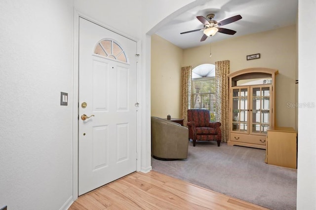 foyer with ceiling fan and light hardwood / wood-style floors