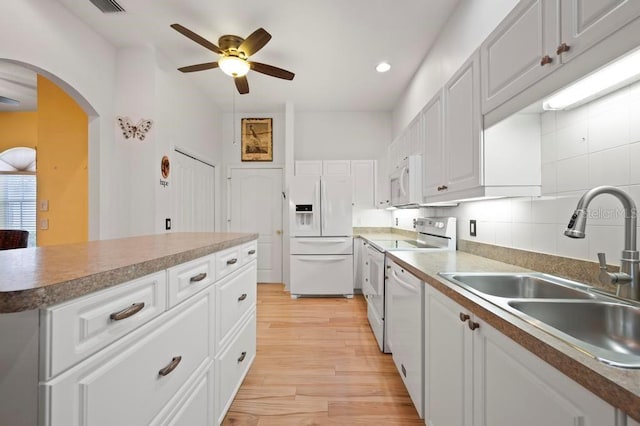 kitchen featuring backsplash, white appliances, ceiling fan, sink, and white cabinets