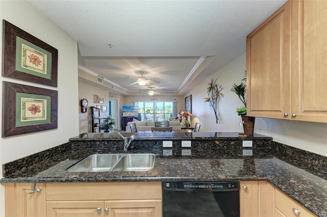 kitchen featuring dark stone countertops, black dishwasher, and sink