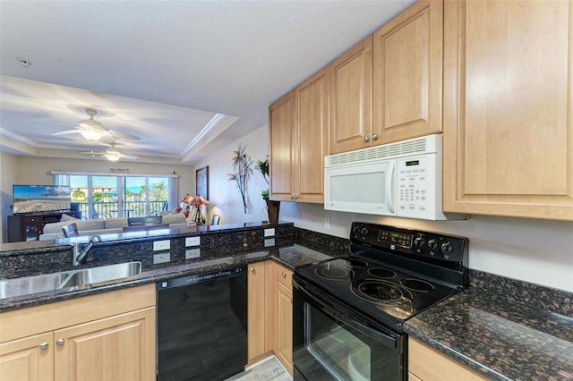 kitchen featuring sink, light brown cabinets, dark stone counters, and black appliances