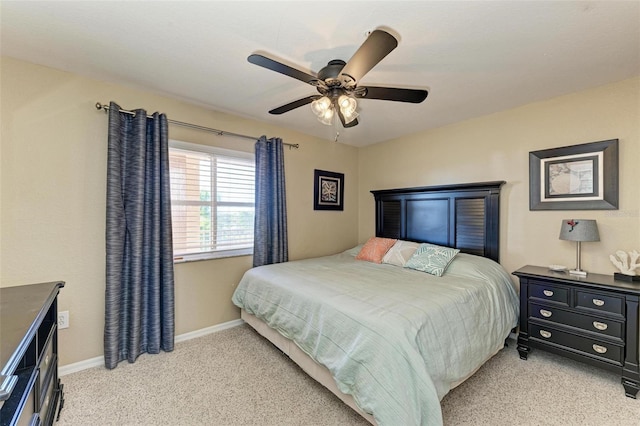 bedroom featuring light colored carpet and ceiling fan