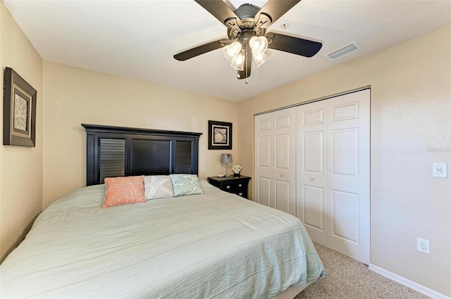 bedroom featuring ceiling fan, a closet, and light carpet