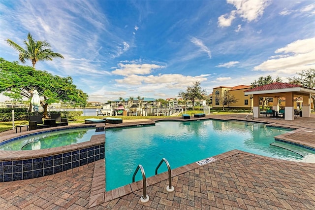 view of pool with an in ground hot tub and a gazebo