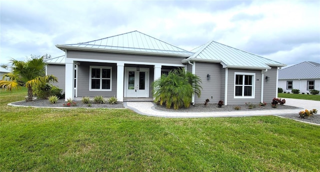 view of front of property featuring a front yard and french doors