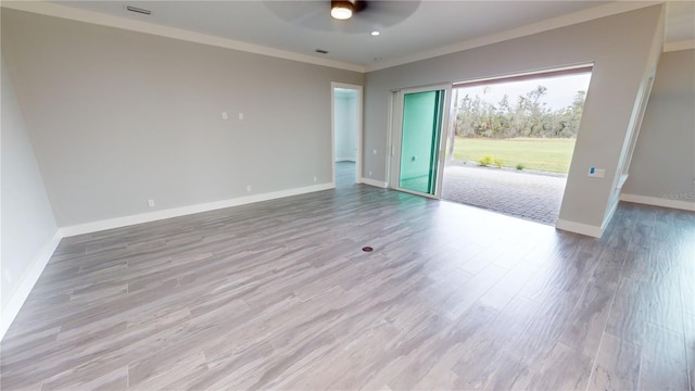 empty room featuring light wood-type flooring, ceiling fan, and crown molding