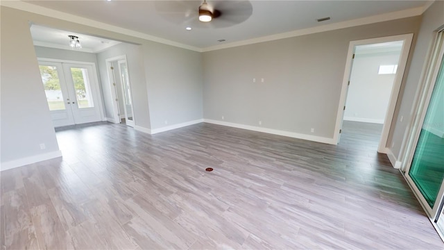 unfurnished room featuring ceiling fan, french doors, crown molding, and light hardwood / wood-style flooring