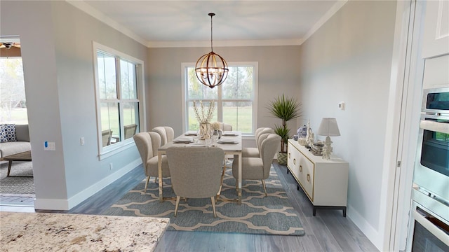 dining room with dark wood-type flooring, an inviting chandelier, and ornamental molding