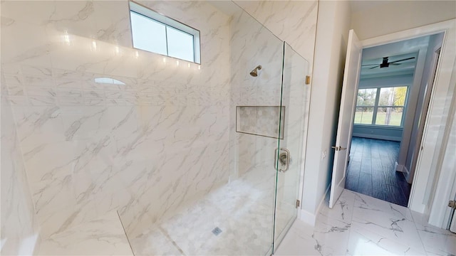 bathroom featuring ceiling fan and tiled shower