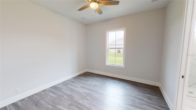 empty room with ceiling fan and wood-type flooring