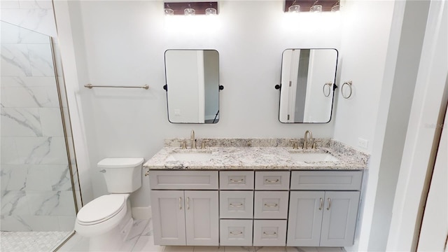 bathroom with toilet, a tile shower, and vanity