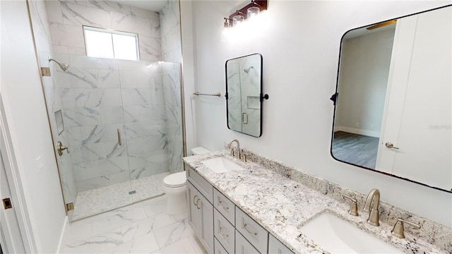 bathroom featuring toilet, vanity, and a shower with door