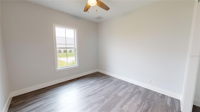 unfurnished room featuring ceiling fan and hardwood / wood-style flooring