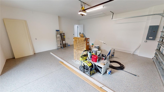 garage featuring electric water heater, a garage door opener, and electric panel