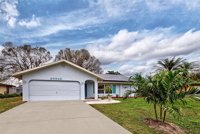 ranch-style house with a front yard and a garage