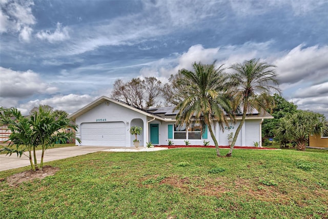 view of front of property featuring a front lawn and a garage