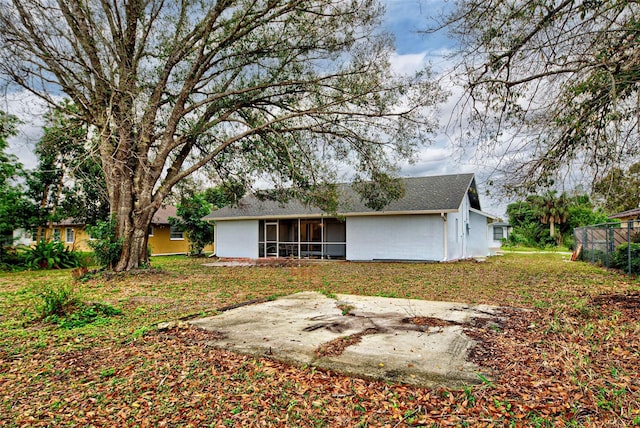 rear view of house with a yard