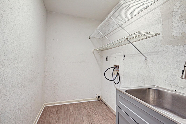 clothes washing area with washer hookup, electric dryer hookup, and wood-type flooring