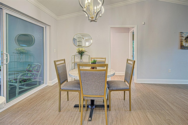 dining area featuring an inviting chandelier, ornamental molding, and light wood-type flooring