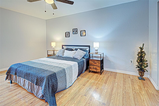 bedroom with light hardwood / wood-style floors and ceiling fan