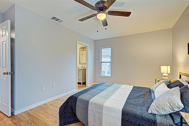 bedroom featuring connected bathroom, ceiling fan, and light hardwood / wood-style flooring