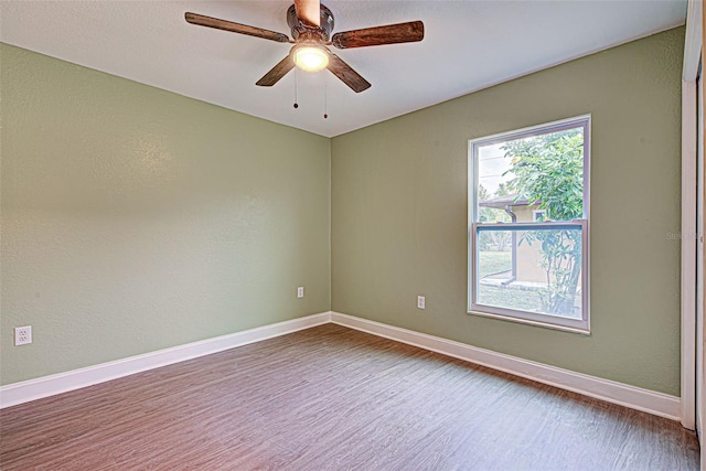 spare room featuring ceiling fan and dark hardwood / wood-style flooring