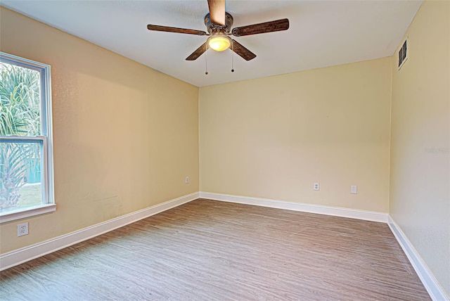 unfurnished room with a healthy amount of sunlight and ceiling fan