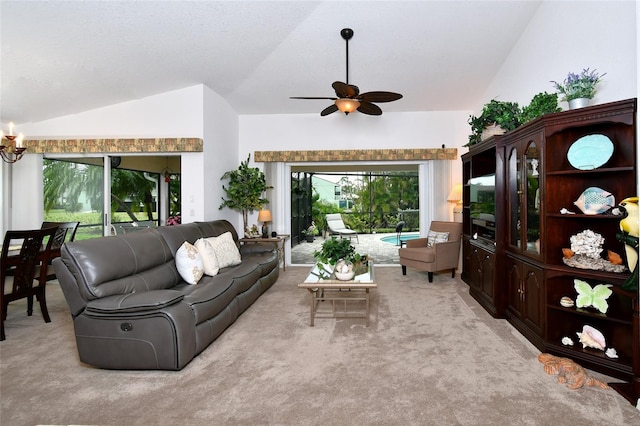 living room with plenty of natural light, high vaulted ceiling, ceiling fan with notable chandelier, and light colored carpet