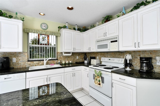 kitchen with white appliances, white cabinetry, tasteful backsplash, and sink